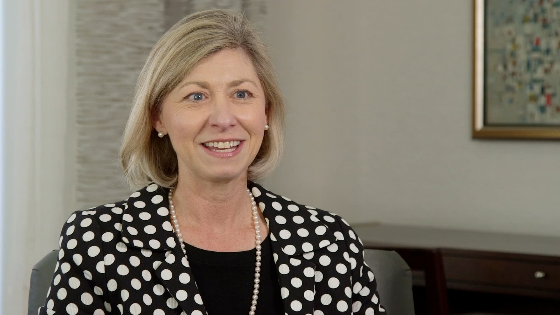 A woman smiling while sitting for an on-camera
interview