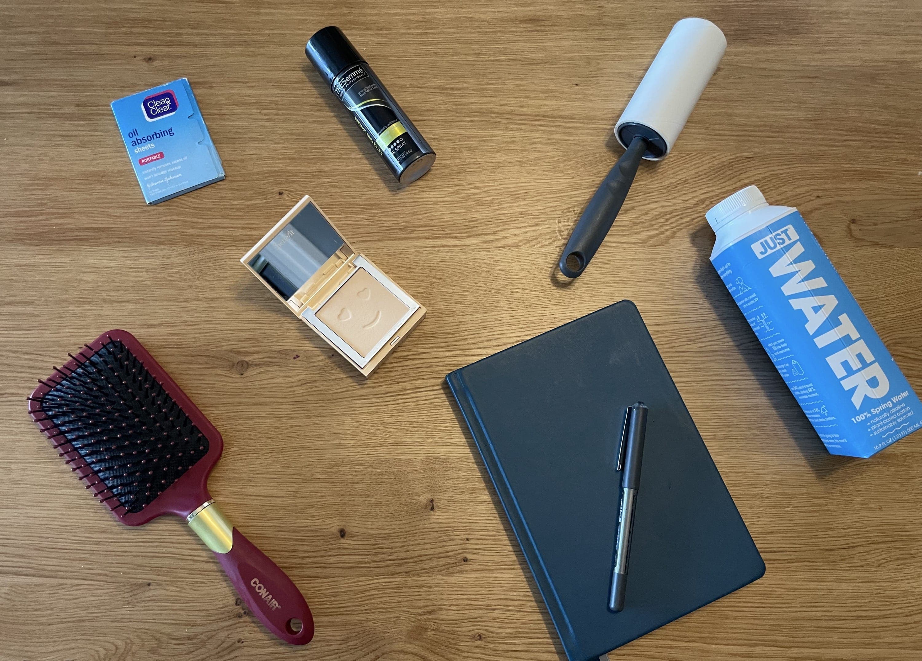 Brush, hair spray, and oil absorbing sheets on a
table